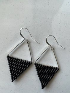 This listing is for these beautiful double triangle earrings. The beads are Japanese Miyuki Delicas and black matte. One side is adorn by a silver plated triangle finding and the other side is a brick stitch triangle. Super fun and light weight earrings. The ear wires are silver plated and are nickel and lead free. These earrings are made to order with love. All orders are packaged with care and shipped in recyclable material. If you love the pattern, but would prefer different colors then pleas Modern Black Triangle Jewelry, Minimalist Triangle Nickel-free Earrings, Minimalist Nickel-free Triangle Earrings, Minimalist Beaded Drop Earrings, Silver Triangle Earrings For Party, Silver Triangle Party Earrings, Adjustable Geometric Black Jewelry, Adjustable Black Geometric Jewelry, Minimalist Handmade Triangle Earrings