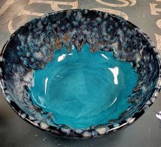 a blue bowl sitting on top of a table