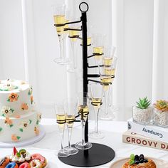 a table topped with lots of desserts and glasses on top of eachother