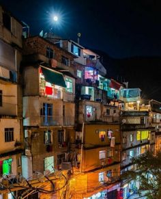 an urban area at night with lots of windows and balconies on the buildings