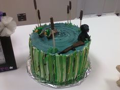 a cake with green icing and sticks sticking out of it