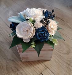 an arrangement of flowers in a wooden box