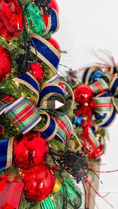 two christmas trees decorated with ribbons and ornaments