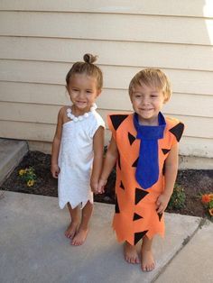 two young children dressed up in costumes