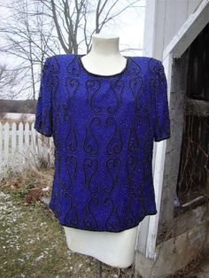 This is a vintage beaded and sequin top from the 1980's-90's by Stenay.  It's a pretty cobalt blue silk, with beaded paisley designs all over.  It's labeled a size XL, and opens down the back with a well working zipper.  This top is in excellent shape, and would great for the Holidays, or just with jeans.  Comes from a smoke free home.Measurements:  Bust:  42"   Waist: 38"    Hip:  44"   Across Shoulder:  17.5"    Sleeve Length: 11"     Length from Shoulder:  25" Please ask me any questions you Fitted Blue Beaded Tops, Blue Embellished Top For Evening, Heavy Winter Coat, Silk Sleeveless Top, Beaded Blouse, Beaded Top, Paisley Design, Blue Silk, Sequin Top