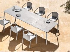 an outdoor table and chairs are arranged in the shape of a rectangle shaped dining table