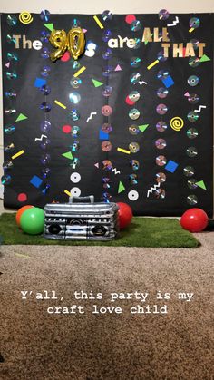 a party decoration with balloons and streamers in front of a blackboard that says, the 50 are all that