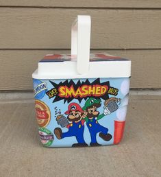 a blue lunch box with an image of mario bros on it