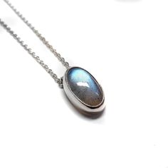 This classic silver shows off the elongated blue oval labradorite stone.  Find more in the link down below: https://www.etsy.com/ca/shop/NaheyiyiStudio?ref=shop-header-name&listing_id=1129602768&search_query=labradorite Materials: *  Pendant Labradorite/ Fine Silver *  Chain Sterling Silver Size:       *  Pendant 16x10x6mm   *  Chain 41cm  Shipping Information * Dispatched from Toronto, Canada. * We employ registered shipping services that provide a tracking number. Delivery usually takes 4-14 b Oval Labradorite Cabochon Jewelry, Oval Cabochon Labradorite Jewelry, Minimalist Silver Necklace With Labradorite, Oval Labradorite Necklace With Large Stone, Labradorite Cabochon Oval Pendant Jewelry, Minimalist Silver Labradorite Necklace, Labradorite Cabochon Oval Pendant, Silver Oval Labradorite Necklace, Silver Labradorite Oval Necklace