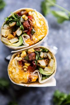 two burritos filled with vegetables and meat