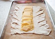 some cheese is sitting on top of the dough and ready to go into the oven