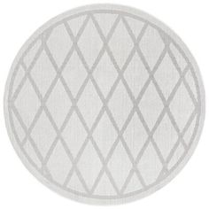 a round rug with white and grey squares on the center, in front of a white background