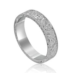 a wedding band with intricate engraving on it