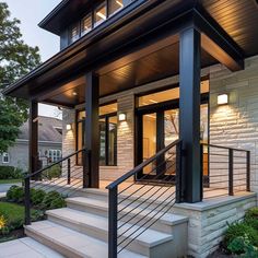 a house with stairs leading up to the front door and side porches on both sides