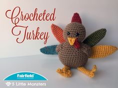 a crocheted turkey sitting on top of a table next to a white wall