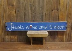 a wooden sign that says hook, we're and sinker next to a bench