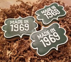 three made in 1950 cookies sitting on top of some wood chips