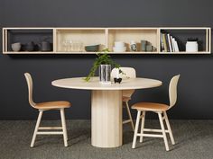 a table with two chairs and a shelf above it