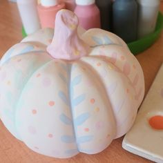 a cake shaped like a pumpkin sitting on top of a table next to other items