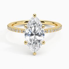 a yellow gold engagement ring with an oval cut diamond and pave set diamonds around the band