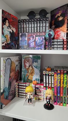 the shelves are filled with anime books and figurines