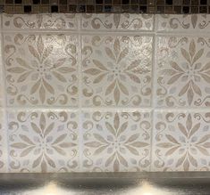 a stove top oven sitting inside of a kitchen next to a tile backsplash