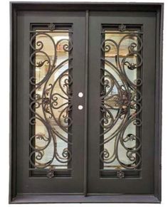 an iron door with glass panels and decorative designs on the front doors, which are dark brown