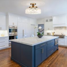 a large kitchen with an island in the middle