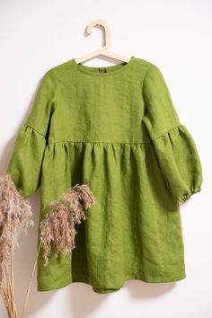 Lovely dress is with a subtle embroidered skirt and slightly puffed sleeves.  You can also choose without embroidery, Please let me know when you order. Model wearing OLIVE colors dress. Dresses in other colours:  https://www.etsy.com/your/shops/FlowermilkKids/tools/listings/769393841 -Medium weight linen (180g/m) -Made from Oeko-Tex certified 100 % linen fabric  (guaranteeing that no harmful chemicals have   been used during the manufacturing process assuring your safety) -Pure washed linen loo Green Cotton Dress With Gathered Sleeves, Embroidered Long Sleeve Linen Dress For Spring, Cotton Dresses With Bishop Sleeves For Spring, Solid Tunic Dress For Spring, Solid Color Tunic Dress For Spring, Solid Color Bishop Sleeve Dress For Spring, Cotton Dress With Gathered Bishop Sleeves, Linen Puff Sleeve Dress With Ruffles, Green Long Sleeve Dress With Gathered Sleeves