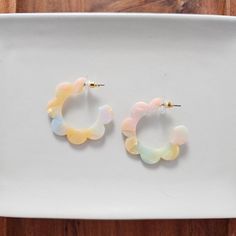 Add a retro vibe to your outfit with our Flora Hoops. The floral design gives these earrings a unique, eye-catching look that's sure to turn heads. Their lightweight design makes them perfect for everyday wear, while the flower shape makes them ideal for a fun night out. Hypoallergenic stainless steel Lightweight and durable plant-based acrylic 1.5" diameter Kids Athleisure, Athleisure Skirt, Multicolor Sweater, Boyfriend Fit Jeans, Bow Hair Accessories, Fall Denim, Kids Items, Beautiful Sweater, Earring Sale