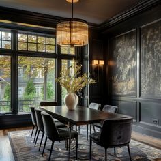 a dining room table with chairs and a vase on it