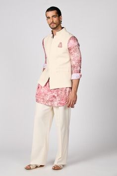 Off white sleeveless nehru jacket with crest embroidery. - Aza Fashions White Sleeveless Cotton Nehru Jacket, White Cotton Nehru Jacket, Cotton Nehru Jacket For Spring Wedding, White Fitted Nehru Jacket For Spring, Traditional Nehru Jacket For Spring Workwear, Sleeveless Nehru Jacket For Spring Wedding, White Nehru Jacket For Spring Formal, White Cotton Nehru Jacket With Stand Collar, White Sleeveless Nehru Jacket For Spring