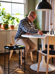 a man sitting at a table with a laptop