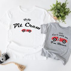 two t - shirts with the words pit crew and an image of a race car