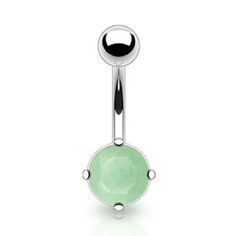 a green stone belly ring with an oval design on the top and two black dots around it