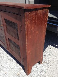 an old wooden cabinet sitting next to a truck