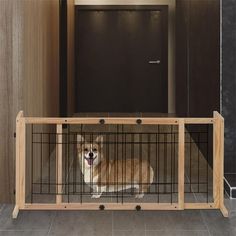 a dog is sitting in its kennel at the entrance to an apartment building,