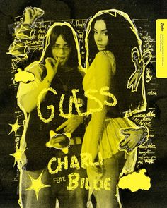 two women standing next to each other in front of a black and yellow poster with writing on it