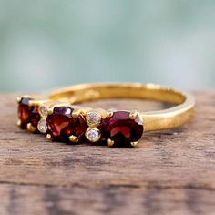 three stone ring sitting on top of a wooden table