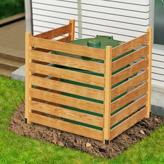 a wooden planter sitting on top of a grass covered field