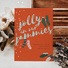 an orange holiday card with the words holly in our pants on it next to some flowers