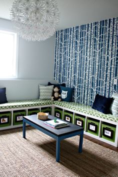 a living room with blue and green wallpaper