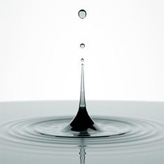 a drop of water that is falling into the water