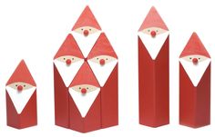 three red wooden santas with white faces