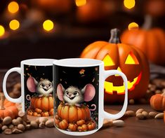 two mugs with mice on them sitting next to pumpkins and jack - o'- lanterns