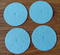 four blue discs sitting on top of a wooden table