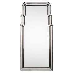 a large mirror with silver trimmings on the sides and an arched frame around it