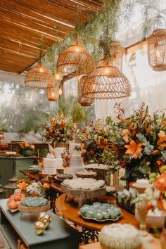 a table filled with lots of cakes and cupcakes on top of wooden tables