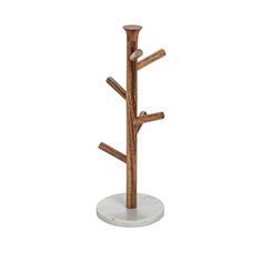 a white marble and wood tree stand with three wooden branches on the top, in front of a white background