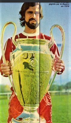 a man holding a trophy in front of his face